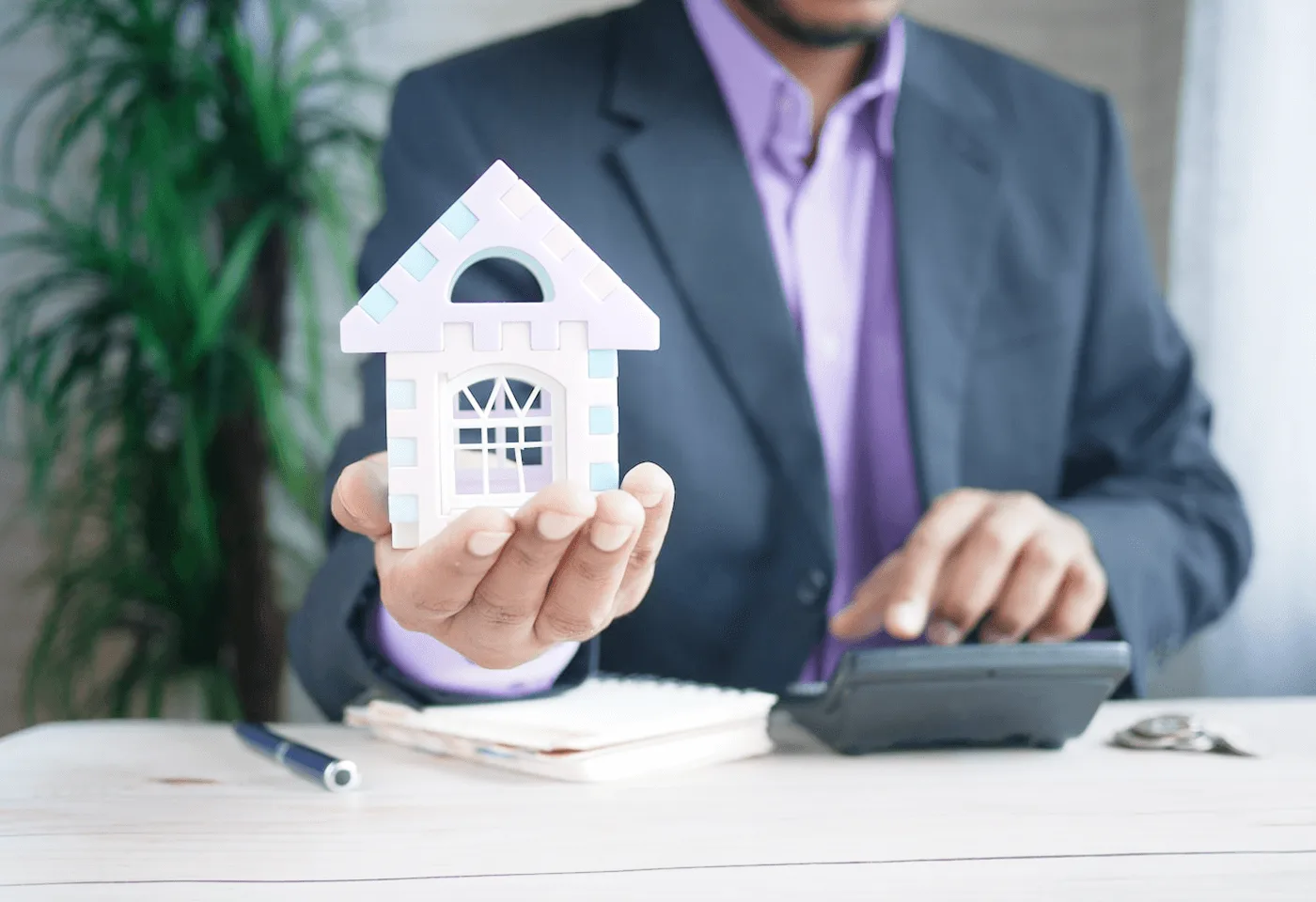 Property owner holding a model house